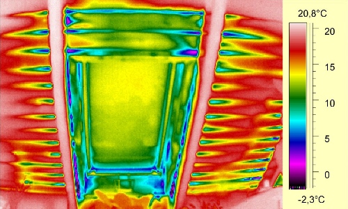 Infrared image showing air leakage around a roof window during a blower door depressurization test